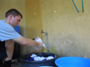 Elder Burbidge doing laundry in a bucket!